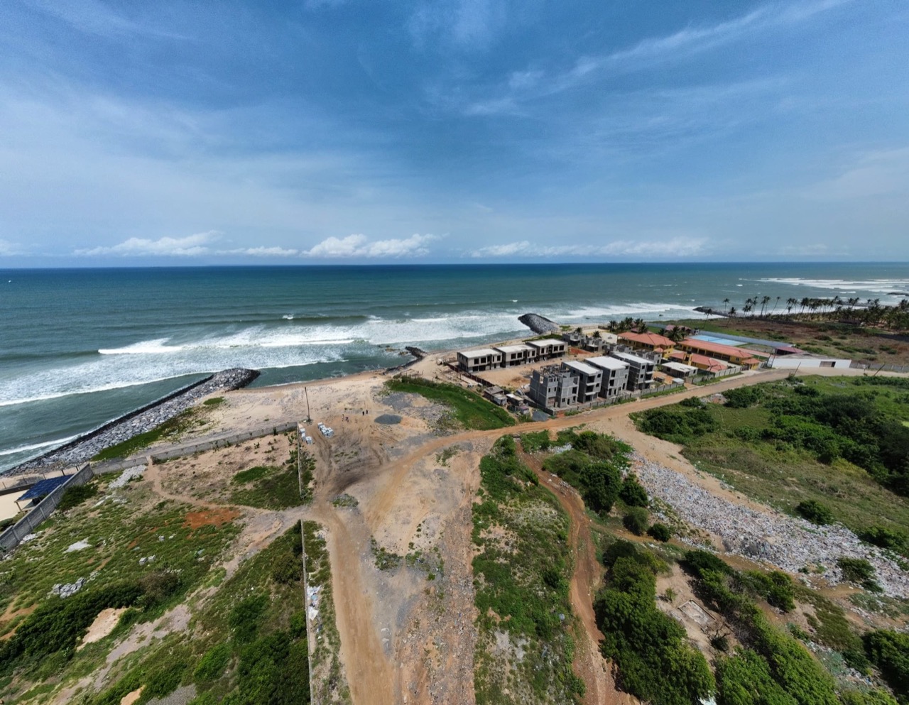 Aerial view of the Prampram coastal plot with the shoreline and sea-defence rocks